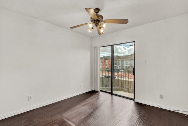 spare room with ceiling fan and dark hardwood / wood-style flooring