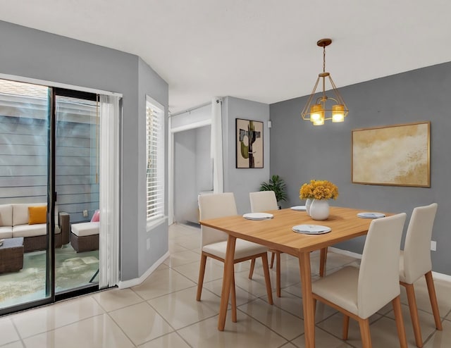 dining room featuring a chandelier, light tile patterned floors, and plenty of natural light