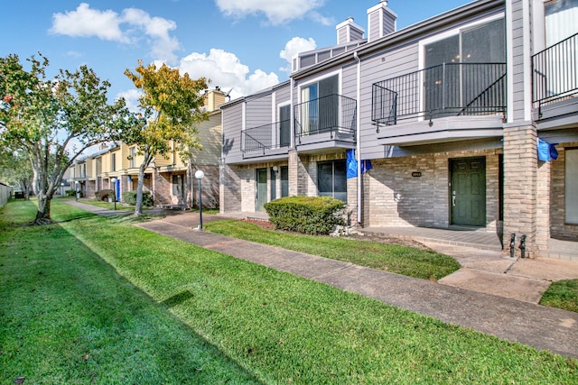 view of property's community with a lawn