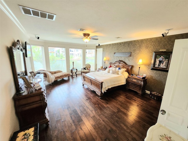 bedroom with dark hardwood / wood-style flooring, ceiling fan, and ornamental molding