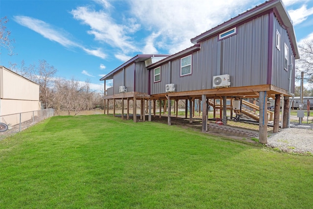 back of house with a yard and ac unit