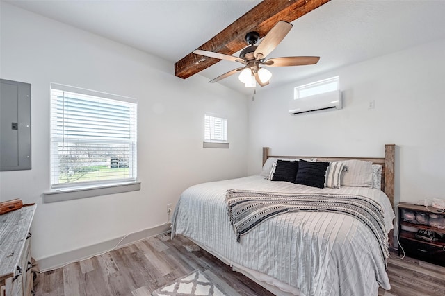 bedroom featuring light wood-type flooring, a wall unit AC, ceiling fan, beam ceiling, and electric panel