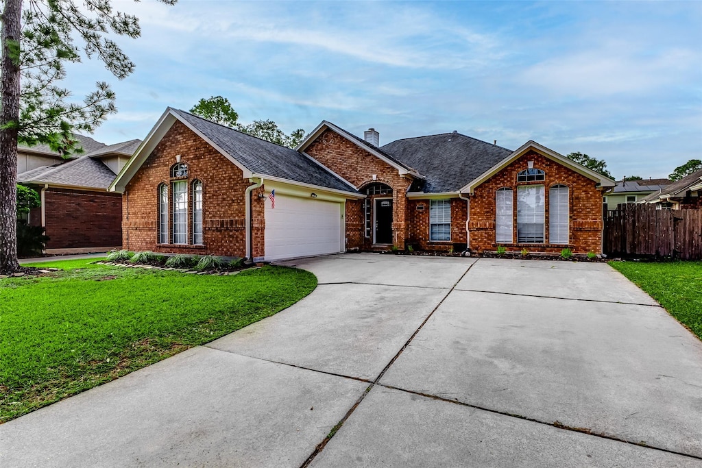 view of front of home with a garage and a front yard