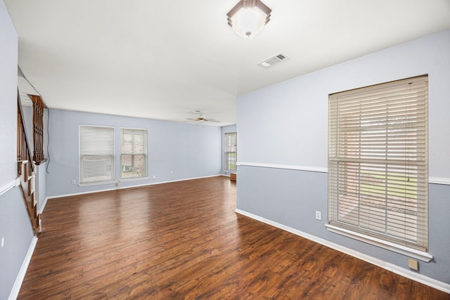 unfurnished room with dark hardwood / wood-style floors and ceiling fan