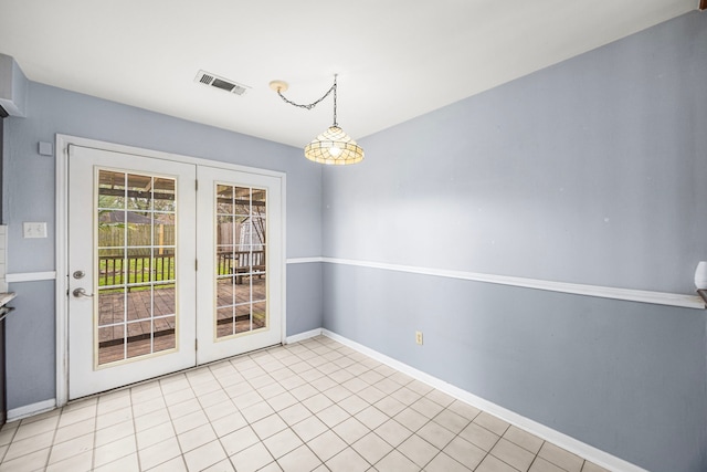 unfurnished dining area featuring light tile patterned floors