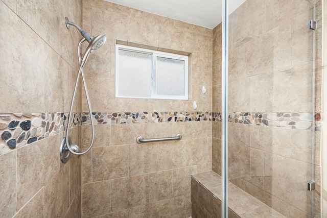 bathroom featuring a tile shower