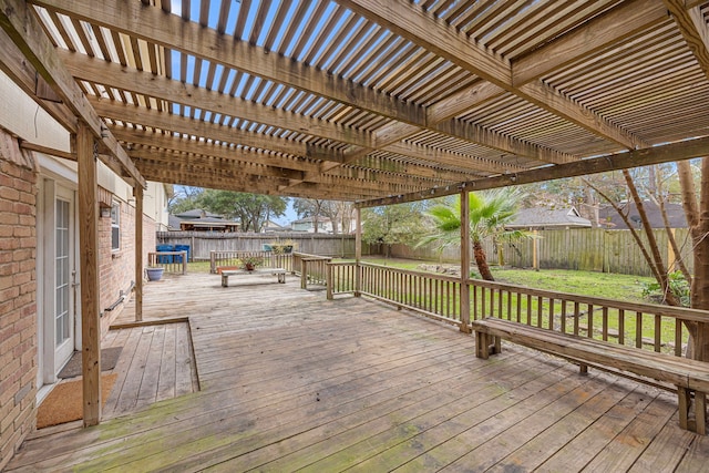 wooden terrace featuring a pergola and a lawn