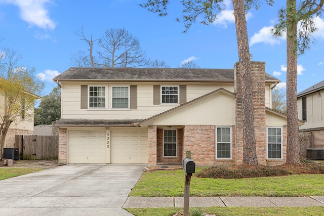 view of front of house featuring a garage, a front yard, and central AC