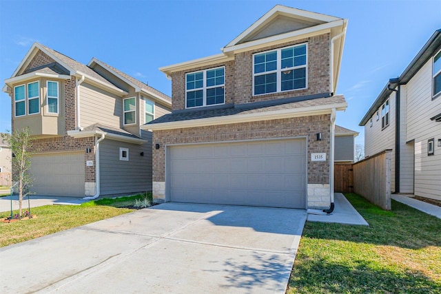 view of front of house with a front yard and a garage