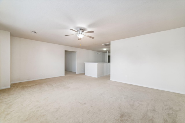 spare room featuring ceiling fan and light colored carpet