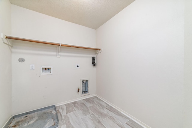 washroom with electric dryer hookup, gas dryer hookup, hookup for a washing machine, and a textured ceiling