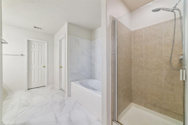 bathroom featuring shower with separate bathtub