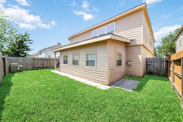 rear view of house featuring a yard