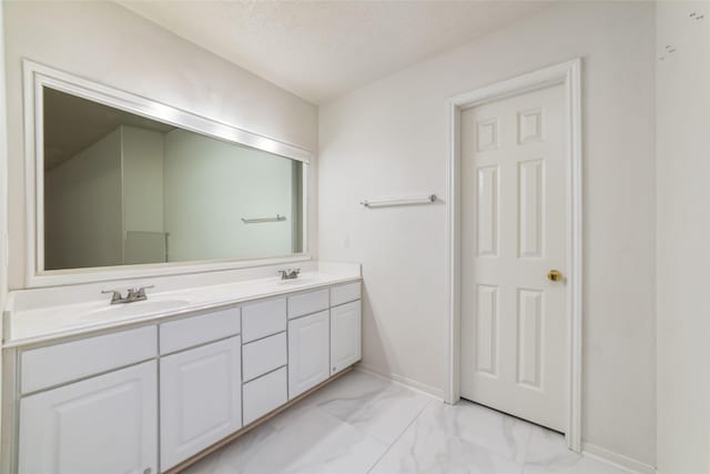 bathroom featuring a textured ceiling and vanity