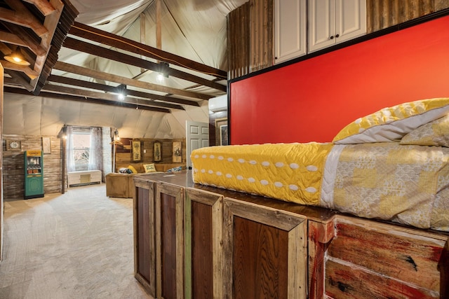 kitchen featuring lofted ceiling with beams, light carpet, and wooden walls