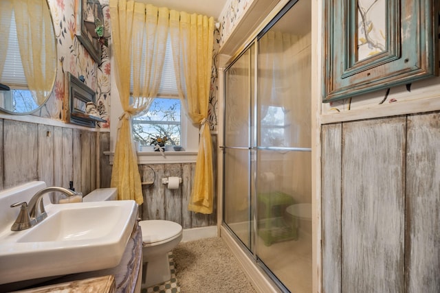 bathroom with sink, toilet, and walk in shower