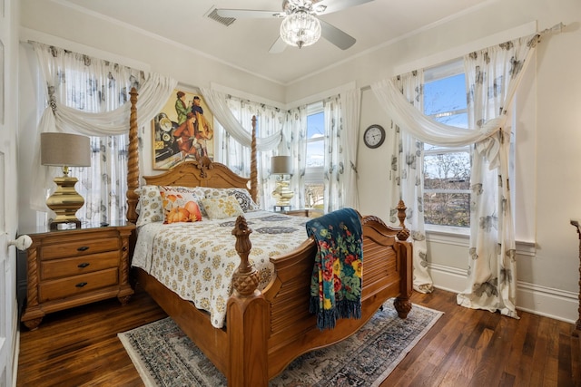 bedroom with ceiling fan, dark hardwood / wood-style floors, and ornamental molding