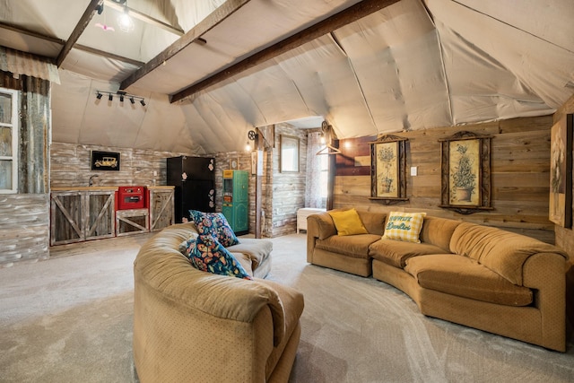 carpeted living room featuring vaulted ceiling with beams and wood walls