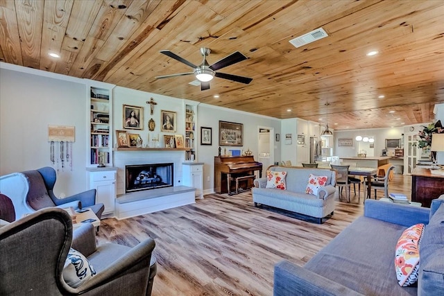 living room with wooden ceiling, built in shelves, light hardwood / wood-style flooring, and ceiling fan