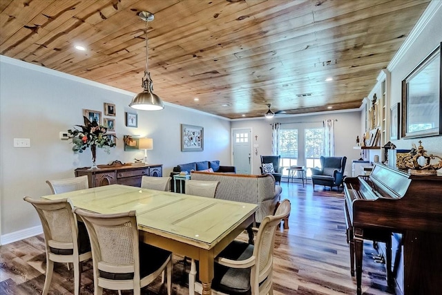 dining space featuring crown molding, wood ceiling, and light hardwood / wood-style flooring