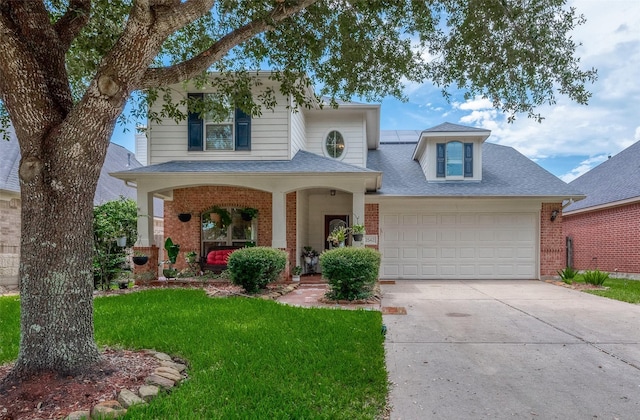 view of front of property featuring covered porch, a garage, and a front lawn