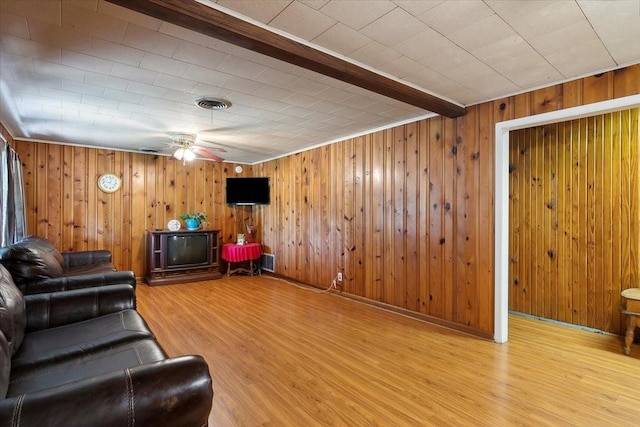 living room with beam ceiling, light hardwood / wood-style flooring, and ceiling fan