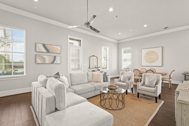 living room with a wealth of natural light, ceiling fan, and dark wood-type flooring