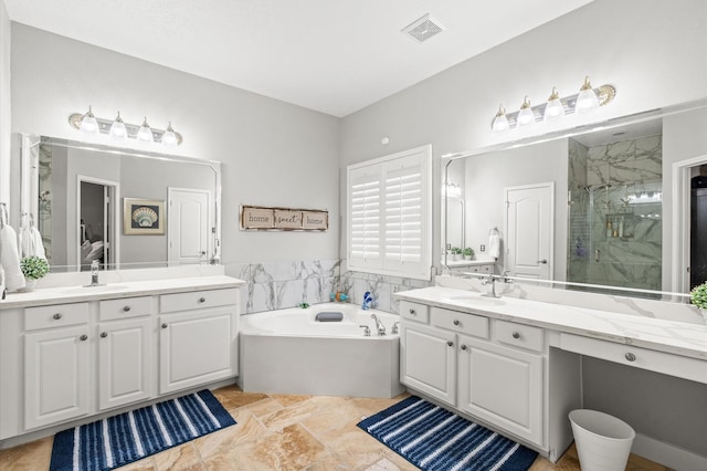 bathroom featuring vanity and shower with separate bathtub