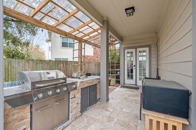 view of patio with a grill, sink, and an outdoor kitchen