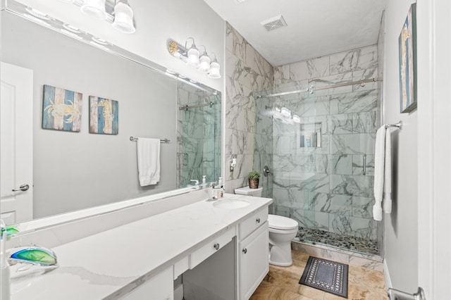 bathroom featuring vanity, toilet, and a shower with shower door