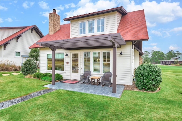 back of property featuring a patio area and a yard