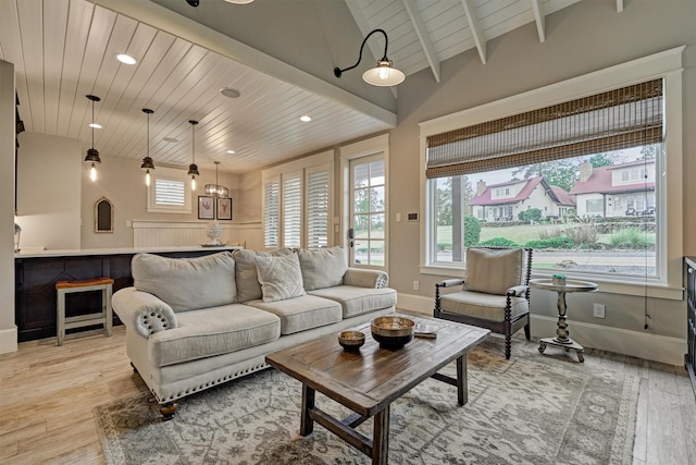 living room with beam ceiling, light hardwood / wood-style flooring, and wood ceiling