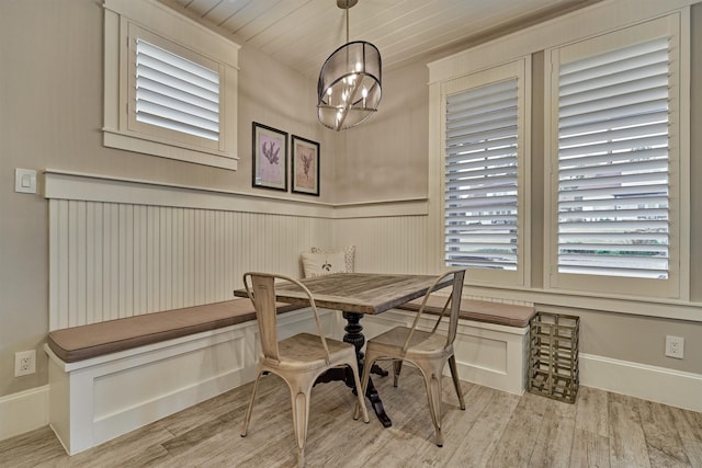 dining room with light hardwood / wood-style floors and an inviting chandelier