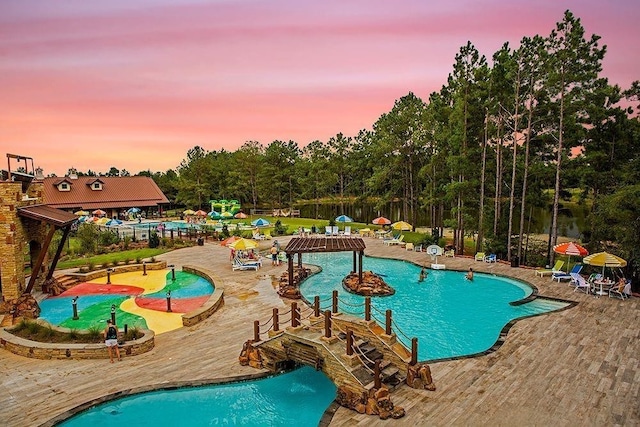 view of pool at dusk