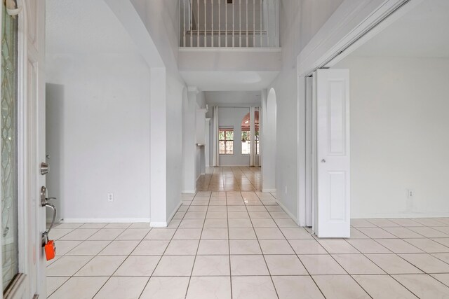 tiled foyer featuring a towering ceiling