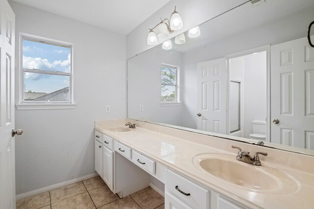 bathroom featuring tile patterned floors, vanity, and toilet