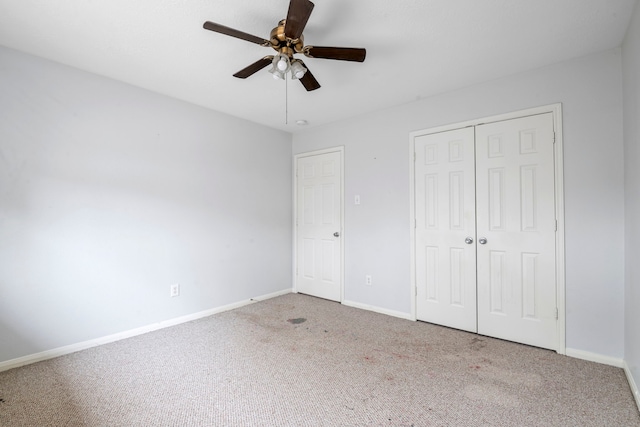 unfurnished bedroom with carpet flooring, ceiling fan, and a closet