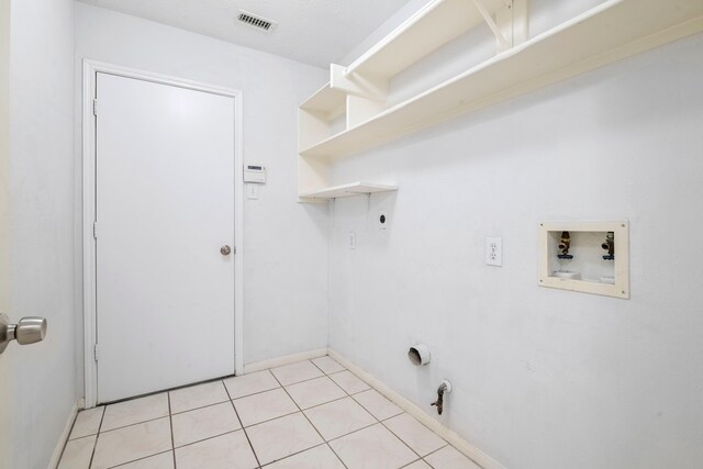 laundry room featuring hookup for an electric dryer, washer hookup, light tile patterned floors, and gas dryer hookup