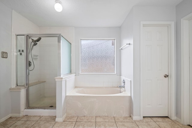 bathroom featuring tile patterned flooring, independent shower and bath, and a textured ceiling