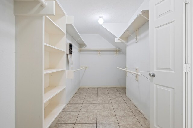 walk in closet with light tile patterned floors