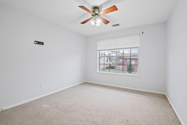 empty room with ceiling fan and carpet