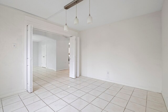 unfurnished room with light tile patterned floors