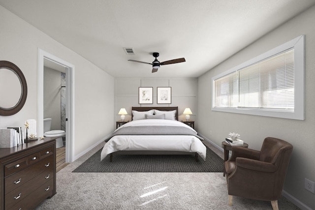 carpeted bedroom featuring ceiling fan and ensuite bath