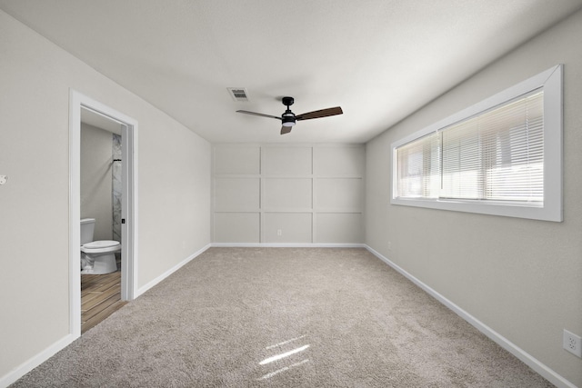 carpeted spare room with ceiling fan