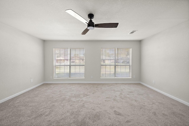 unfurnished room featuring ceiling fan and carpet