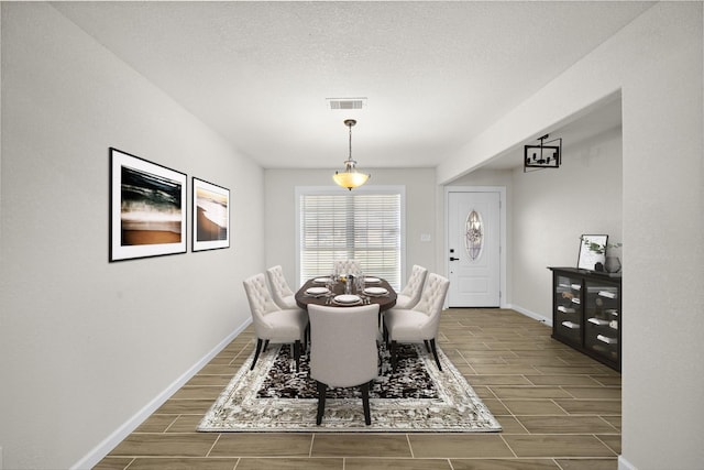 dining space with a textured ceiling