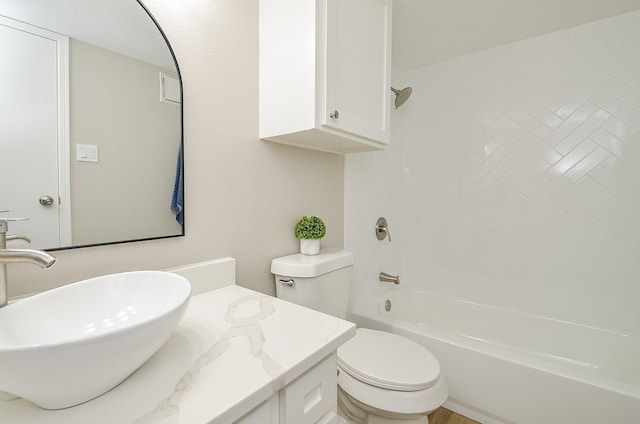 full bathroom with tiled shower / bath combo, vanity, and toilet