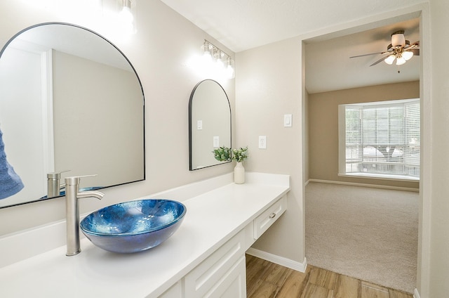 bathroom featuring vanity, wood-type flooring, and ceiling fan