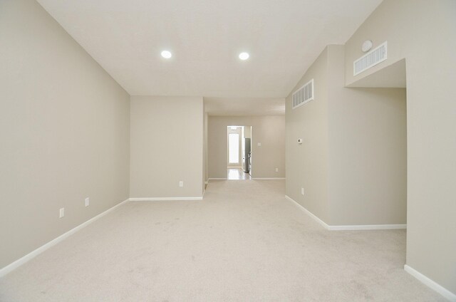 unfurnished room with light colored carpet