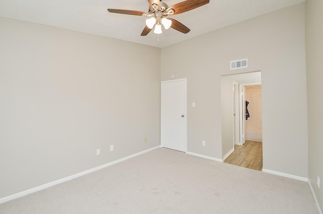 unfurnished bedroom with light colored carpet and ceiling fan